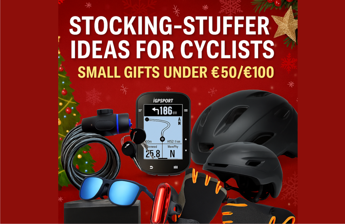 Black bike helmets, cycling gloves, sunglasses, bike computer, light, and lock on red holiday background